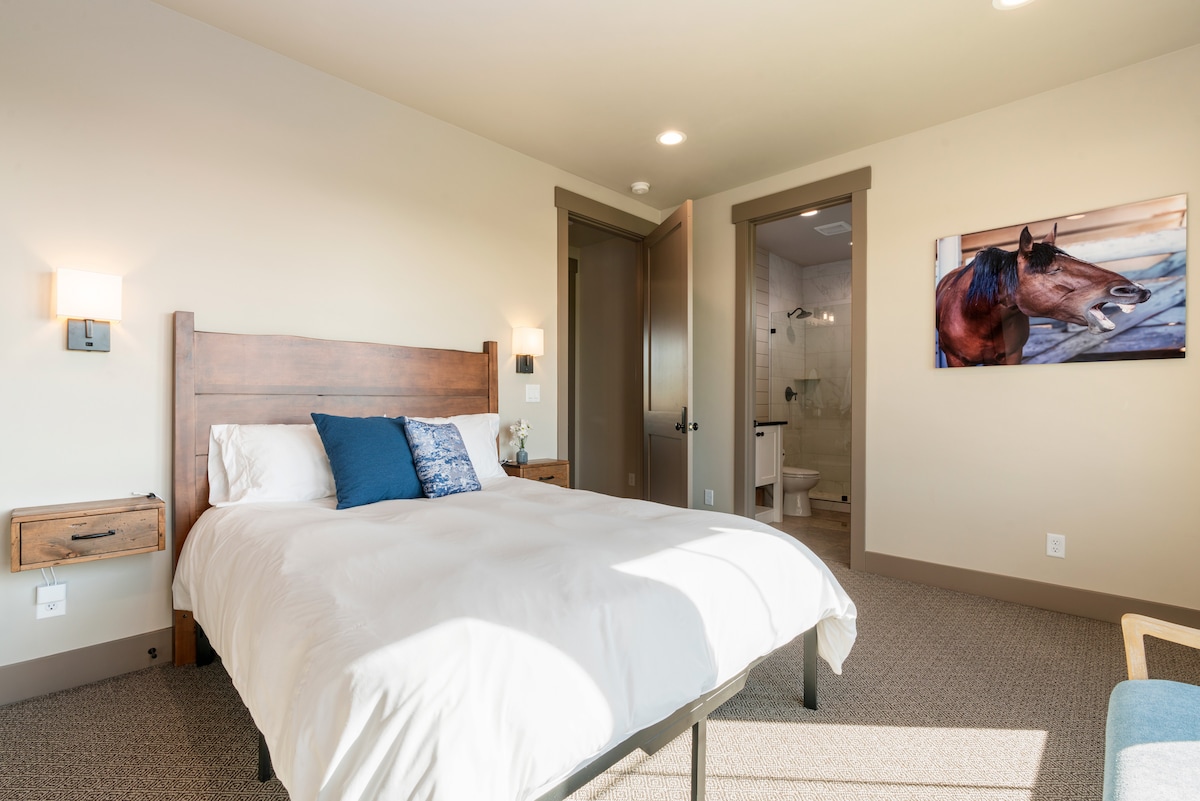 Bedroom #4 serves as a secondary primary bedroom with an ensuite bath and queen bed.