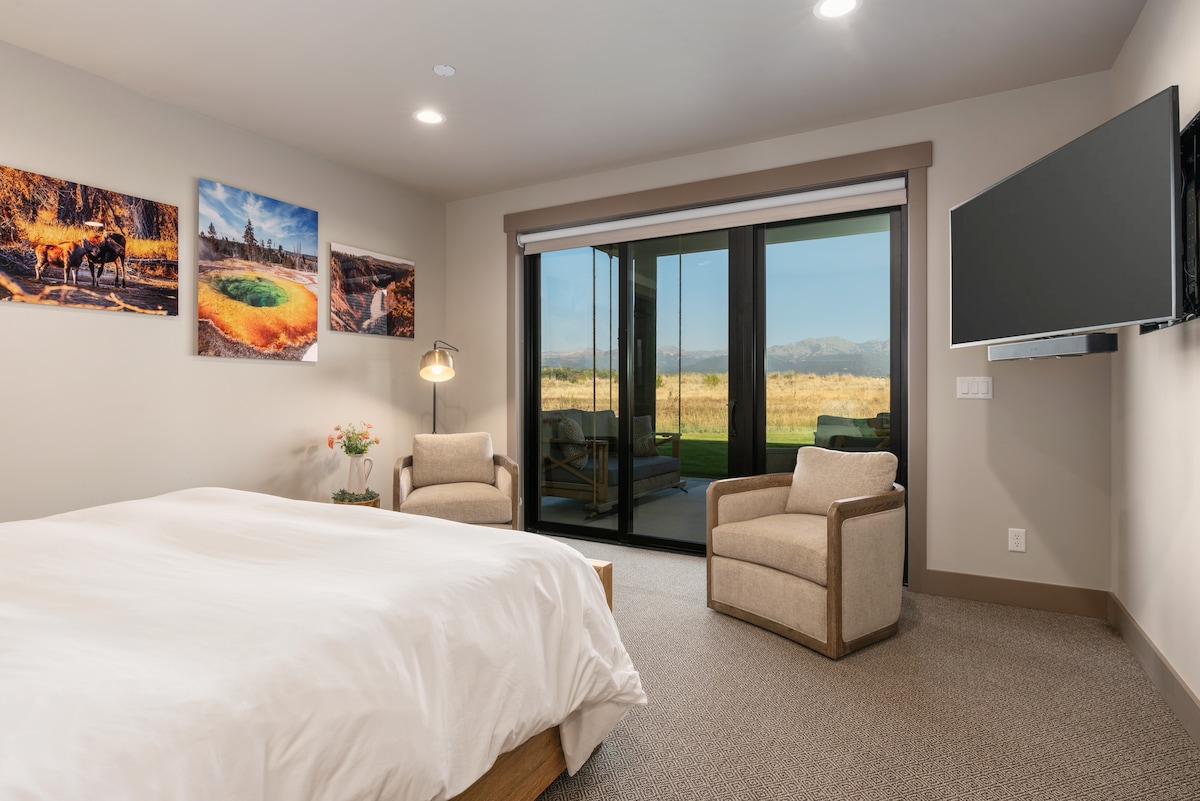 The primary bedroom has direct access to the backyard patio. Stunning Yellowstone photography can also be found throughout the home.