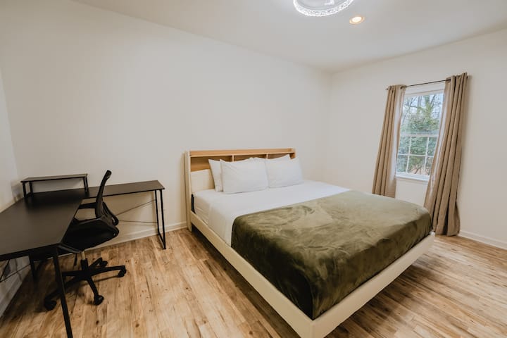 King Bed with 65" Smart TV, and Study desk with chair.
