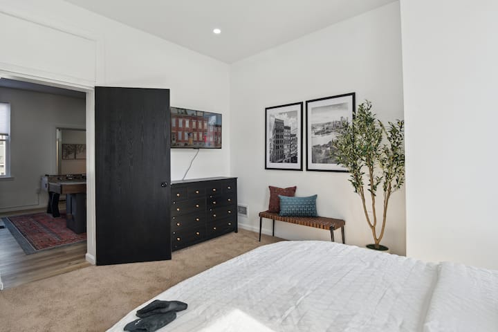 2nd floor Queen bedroom with linens, TV, dresser and closet.