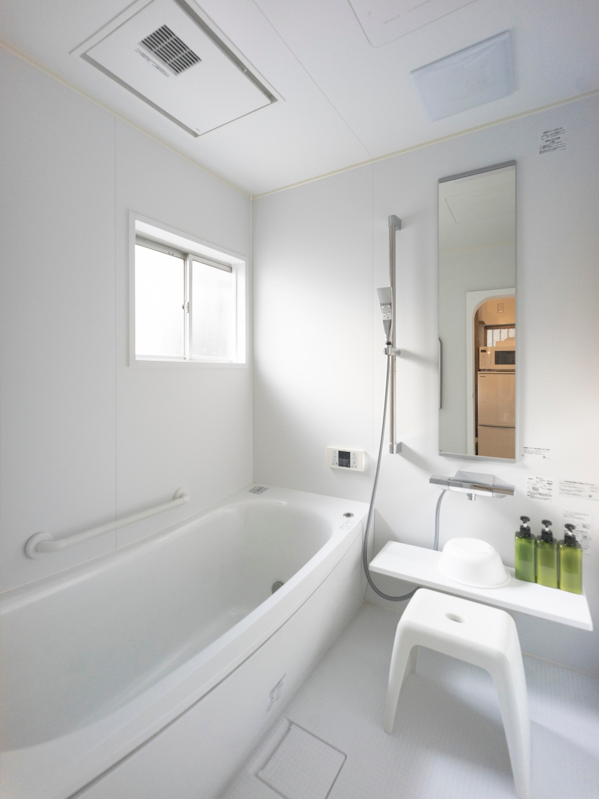 窓から入る光で明るく広い（1.65m角）浴室は、暖房乾燥機も備えていますので、冬も暖かく入浴を楽しむことがができます。
また脱衣コーナー（ダイニングとカーテンで仕切れる）には、大きな洗面台と洗濯機が用意されて、洗濯洗剤や物干しハンガーも用意されています。またコーナーのすぐ横には勝手口がありますので、その外に少量の洗濯物を干すこともできます。徒歩圏にランドリーもあるので、大量の洗濯はそちらがお勧めです。