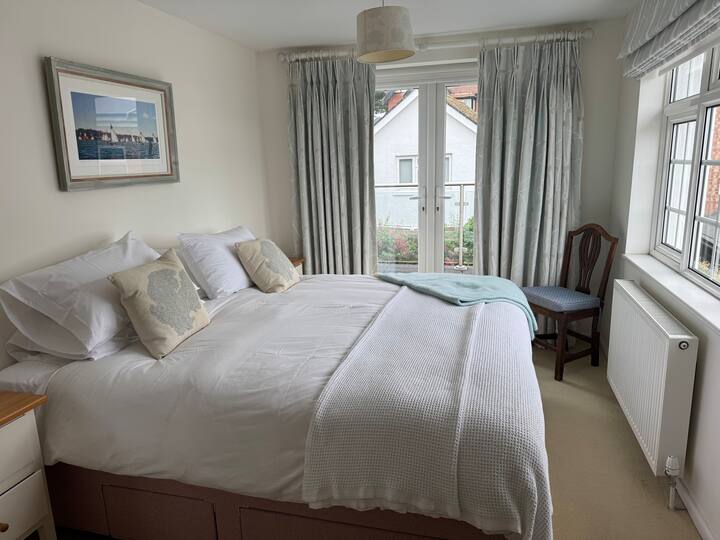 Master Bedroom with glass doors leading to shared balcony.