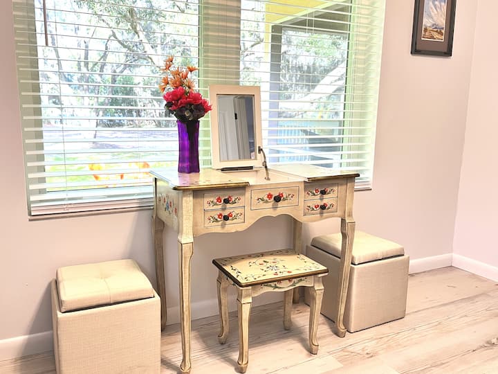 How quaint & 'cottagey' with this painted vanity & matching stool for primping in front of the window & gazing at the lake.  The storage cubes on the side serve to hold not just inside but also on top when you turn the lids over to reveal trays.