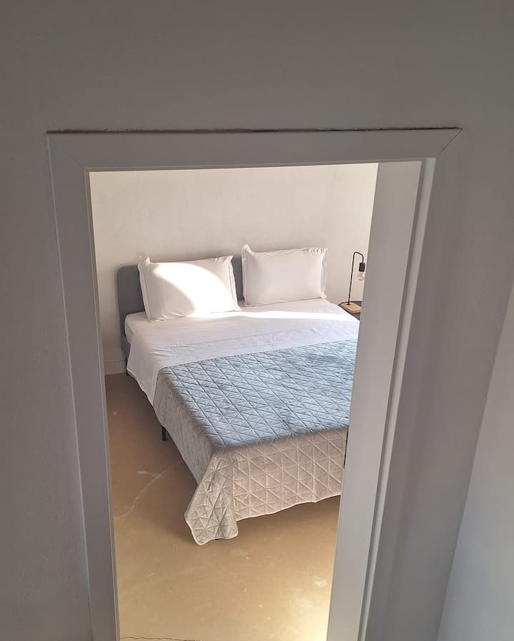 The second bedroom has hanging space for clothing, air conditioning and a luggage rack