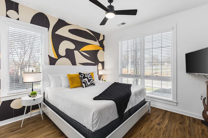 Unit #1: Bedroom #1 on the ground floor with a king bed, ceiling fan, Smart TV, and ensuite bathroom.
