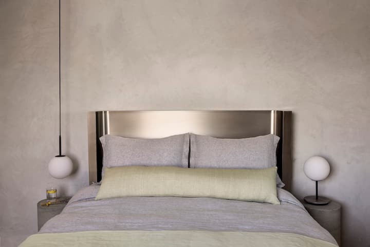 Guest bedroom featuring a custom stainless steel queen bed