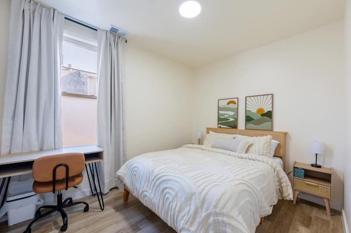 Comfortable queen bedroom with a dedicated work desk and chair — great for remote work or catching up on emails.