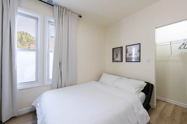 Sunny Bedroom 3 with double windows, a comfortable bed, and a spacious closet for your belongings.