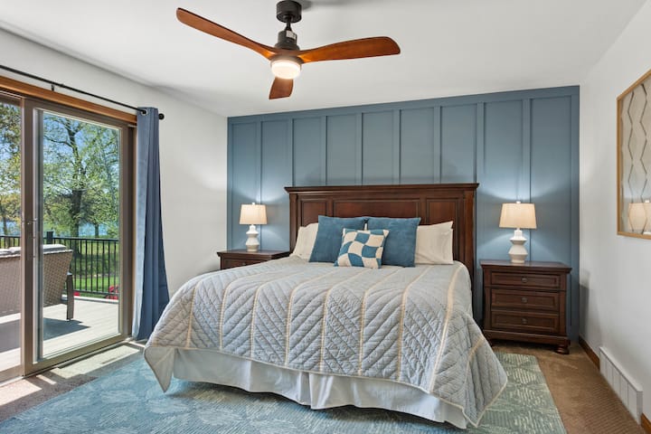 Master bedroom with King bed and walkout patio doors to the deck. Wake up to the sunshine - black out curtains provided. :)