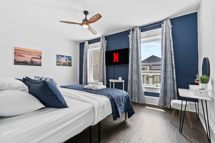 在这间明亮时尚的卧室中放松身心，配备舒适的加大双人床、遮光窗帘和带免费Hulu的智能电视。 自然光线透过大窗户涌入，时尚的梳妆台是梳妆打扮或查收电子邮件的完美场所。