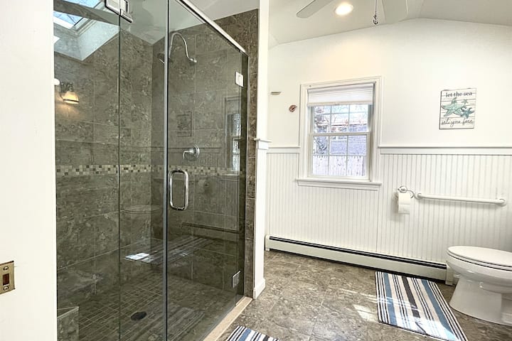 The master bathroom features a spacious shower, perfect for unwinding and refreshing after a day at the beach.