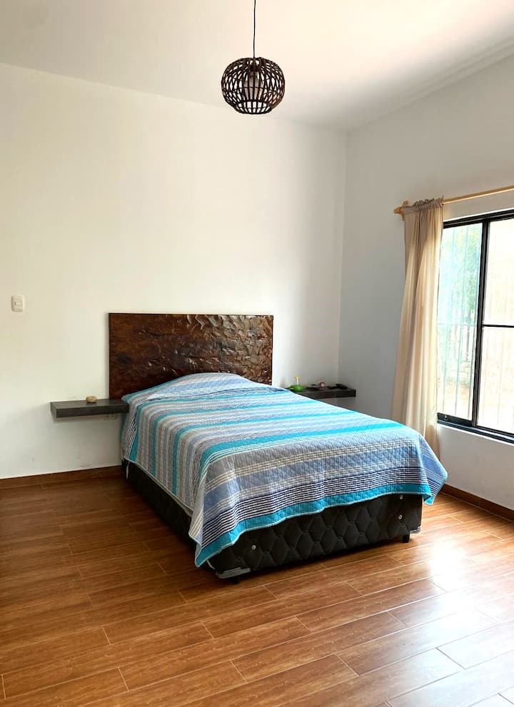 This room has a double bed for two people and an extra single bed. In addition to a private full bathroom.