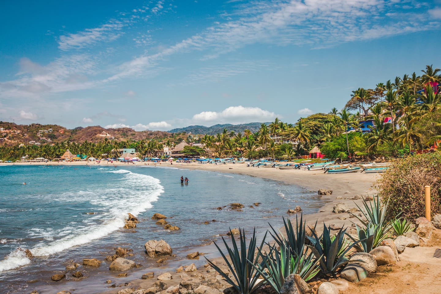 Stand above the Sayulita cove with agave in the foreground and the whole bay laid out below you.