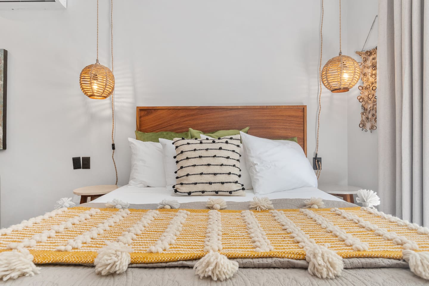 Sink into your queen bed with its wood headboard and rattan pendant lights overhead.