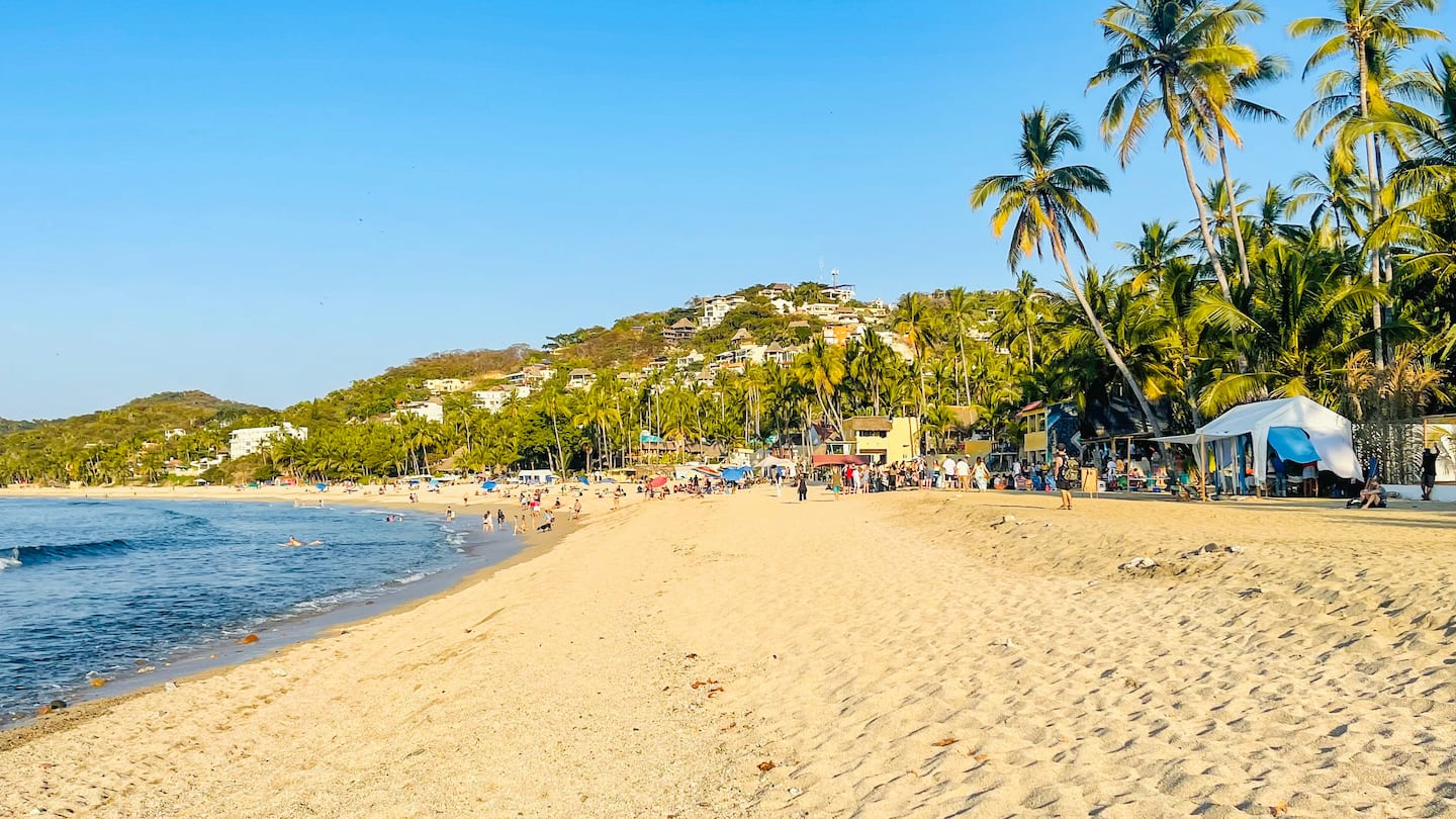 Walk downhill to a wide sandy beach with surf breaks and taco stands steps from the water.