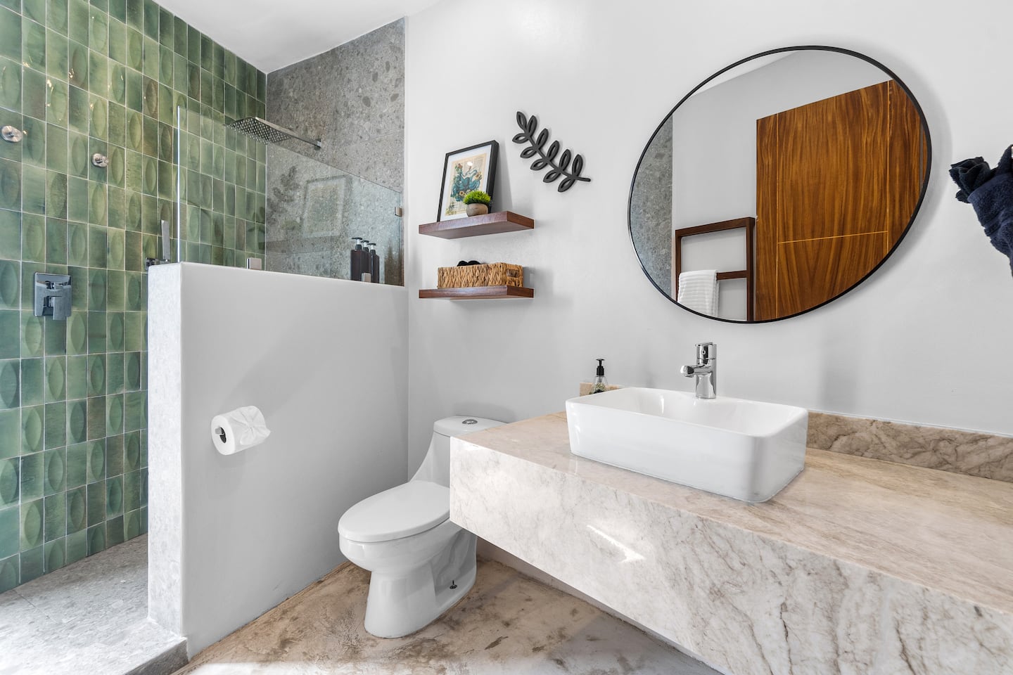 Step into the walk-in shower with its bold green tile surround, one of the most-photographed spots in the unit.