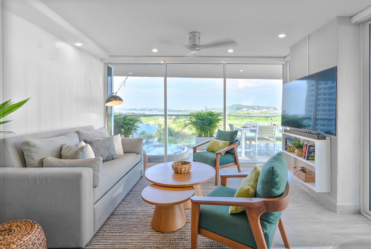 Grote open woonkamer met een prachtig uitzicht, grote tv en bose-geluidssysteem.