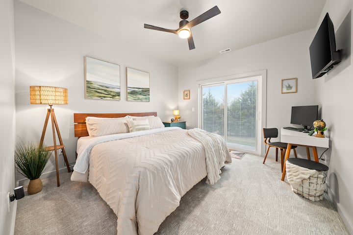 Bedroom: Serene light filled retreat with plush bedding on an excellent king mattress, a sleek desk, and stunning outdoor views!