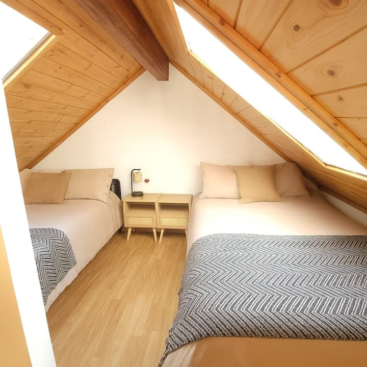 Two double beds in a lofted bedroom with open concept privacy walls. Access loft ladder.