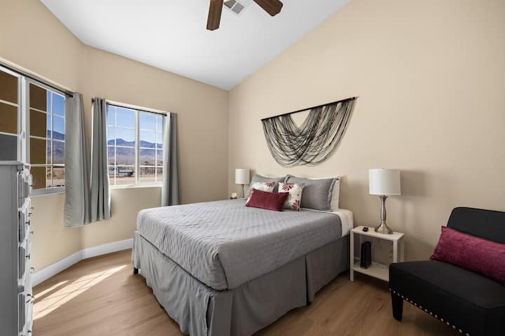 Საძინებელი №2 კომფორტული ორადგილიანი საწოლით, სმარტ-ტელევიზორით და გვერდითი მაგიდებით, მოსახერხებელი პორტით. Დიდი ფანჯრებიდან უამრავი ბუნებრივი სინათლე და მთის ლამაზი ხედი იშლება.