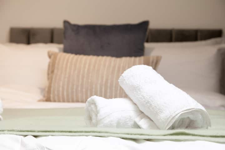 Soft hues and cozy textures define this charming bedroom, where a plush double bed invites relaxation.