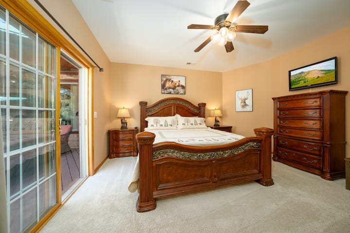 Another bedroom with balcony access through a sliding glass door.