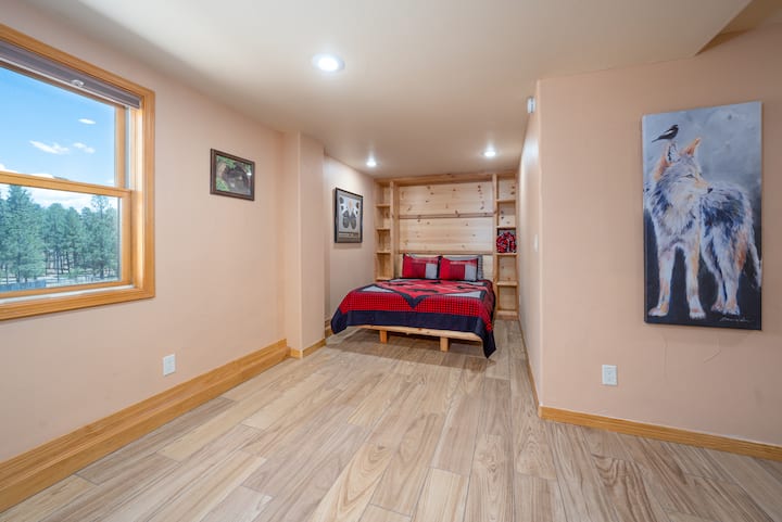 A Queen Murphy bed is in the other half of the open basement area. 