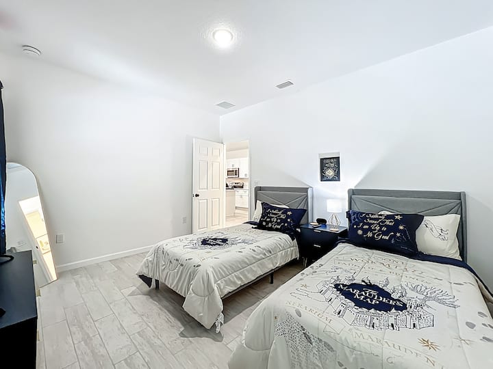 Cozy and bright twin bedroom with a fun Harry Potter theme (updated photos coming soon!). Includes a smart TV, walk-in closet, stand-up mirror, and blackout curtains for a restful night. A full bathroom is conveniently located just steps away.