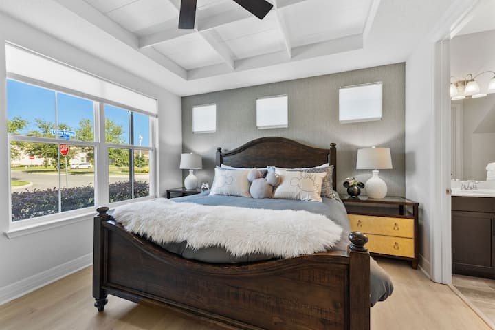 Spacious and stylish, this king bedroom features vaulted ceilings with fan, an ensuite bath, a smart TV, and soft Disney accents for a whimsical yet relaxing vibe.