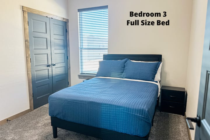 Full bedroom has a ceiling fan, along with a book to read. 