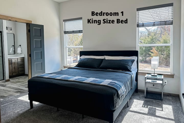 The master bedroom features a smart tv, ceiling fan, and some books. Also has a huge walk-in closet for you to hang your clothes, and luggage racks. 
