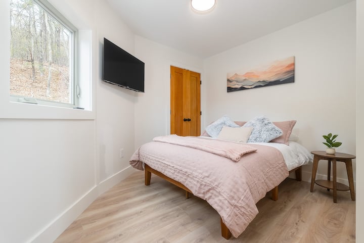 Guest bedroom with 40" Roku Smart TV, full size bed with memory foam mattress and linens provided.