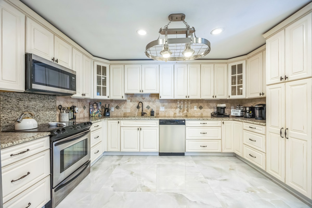 Spacious, fully equipped kitchen with stainless steel appliances, granite countertops, and a cozy coffee station including a new refrigerator and ice maker. 3 varieties of coffee machines.  Perfect for home-cooked meals or your morning brew!
