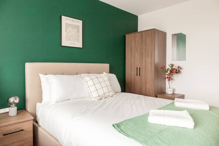 Soft hues and cozy textures define this charming bedroom, where a plush double bed invites relaxation. 