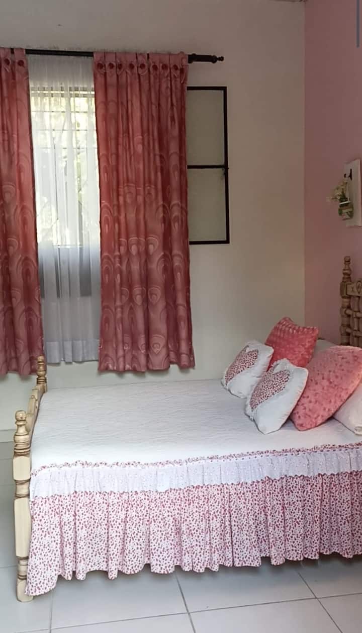 “Habitación Rosada con Encanto: espacio acogedor y luminoso, ideal para 1 o 2 personas. Cuenta con una cama doble, detalles románticos y una atmósfera cálida que invita al descanso. Perfecta para quienes buscan un rincón especial dentro de la casa.”