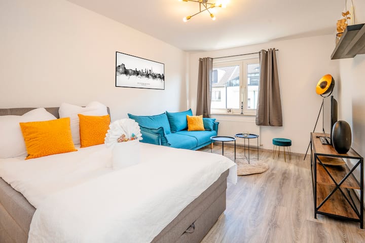 La cama de somier de 1,40 m está en la sala de estar.