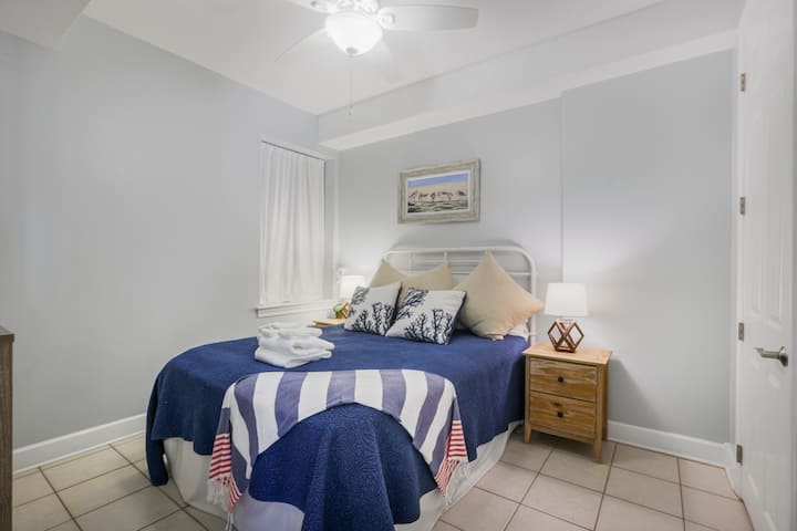 Cozy up after a beach day and drift to sleep wrapped in soft coastal colors and the quiet calm of the shore