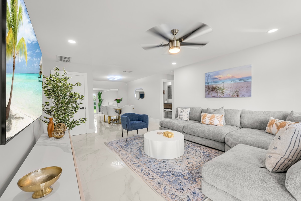 Spacious living room entry takes you to a pass through dining area and into the family room with additional seating and large smart TV area.