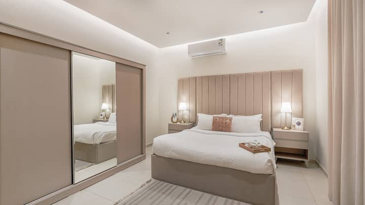 Odmorite se u spavaćoj sobi 1 s plišanom posteljinom, zidom s ogledalima i elegantnom noćnom rasvjetom kako biste se mogli mirno naspavati.

