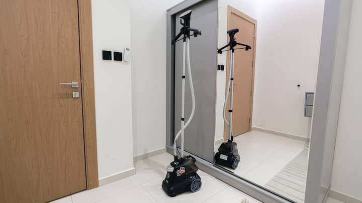Bedroom 3 presents a full-length wall mirror with integrated lighting for both function and design flair.

