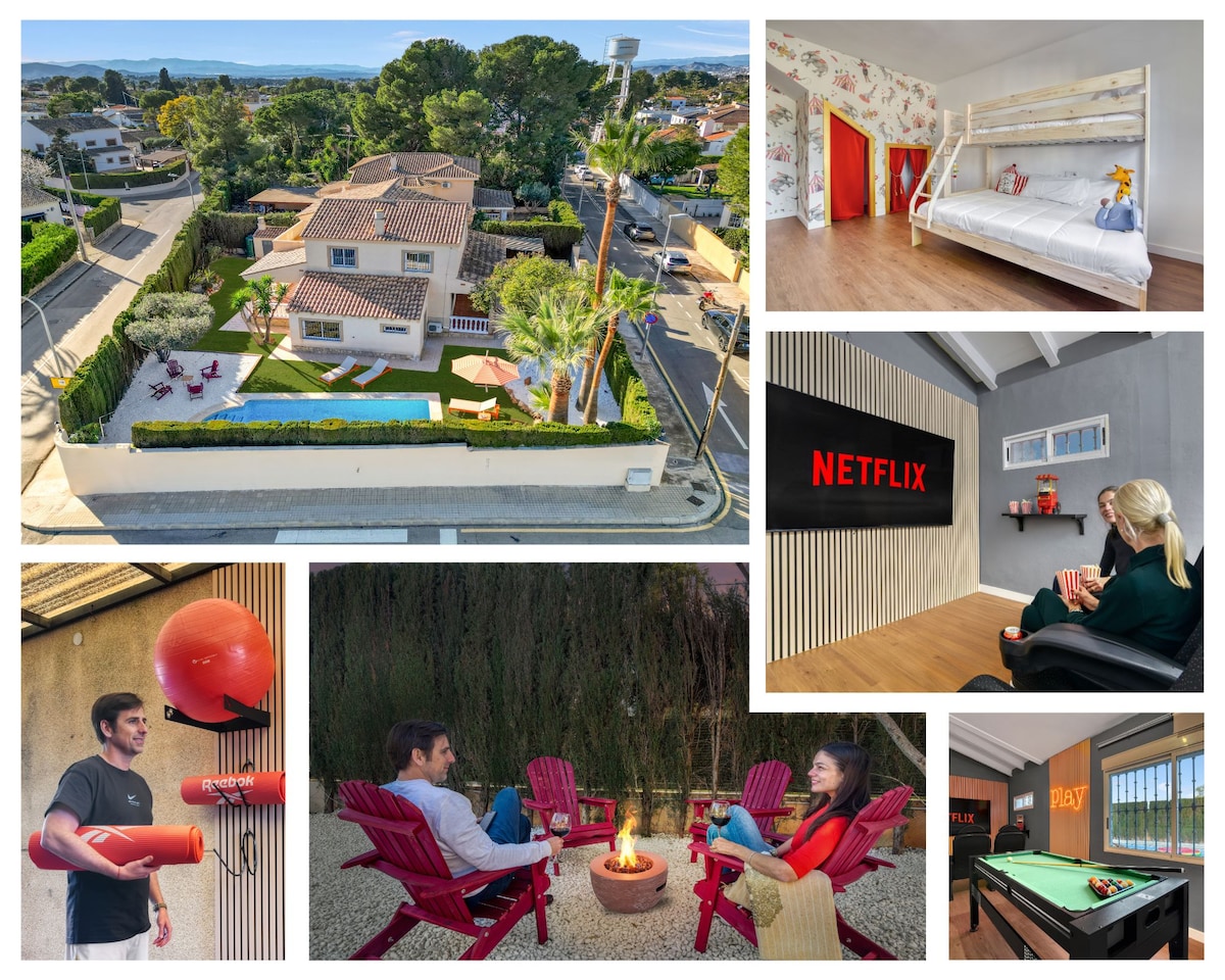 An aerial view of the villa reveals its spacious garden and private pool surrounded by loungers and greenery. The vibrant kids' room and cozy seating area are visible, along with a dedicated cinema space featuring a clear 'NETFLIX' display. An outdoor fire pit is highlighted, offering a relaxing gathering spot.