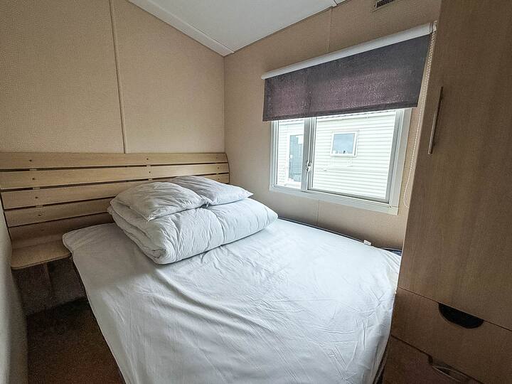 Spavaća soba u kamp-prikolici nudi ugodno utočište nakon cjelodnevnog istraživanja obale Essexa.