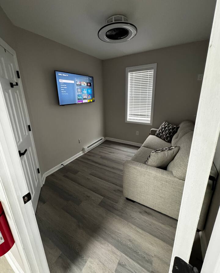 This cute little space doubles as a TV room / bedroom with a pull out sofa bed. Full size mattress and linens provided. Also space in this room to set up a pack n play for kids. Smart TV in this space.