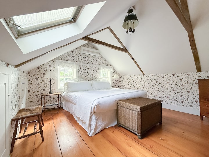 Charming king bedroom on second floor with luxury mattress and high-end linens. Each bedside table has a reading lamp and charging port for convenient device charging.