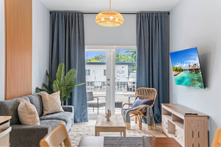 Kick back in this cozy living room oasis! A comfy couch, Smart TV for your binge-watching pleasure, and room-darkening shades for the perfect nap. Step out to the patio for some fresh air and enjoy those chill, laid-back vibes. Pure relaxation!