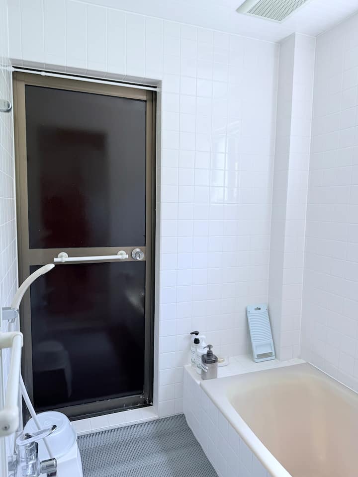 白いタイル基調の清潔感のあるバスルーム。
海で泳いだり、サーフィンを楽しんだ後は、外から直接バスルームにお入りいただけます。