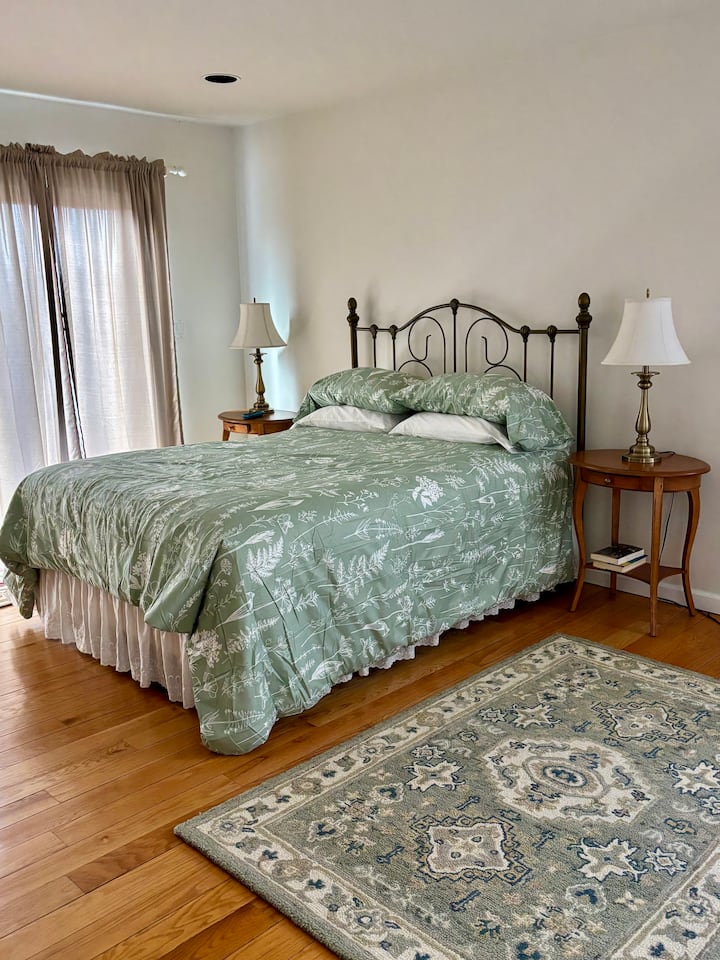 Master Bedroom first floor with private en suite that includes a walk in shower and Jacuzzi tub.