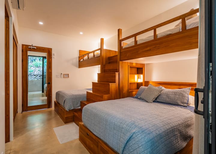 La habitación con literas ofrece dos camas tamaño queen con literas individuales en la parte superior, un baño privado y aire acondicionado para mayor comodidad y conveniencia.