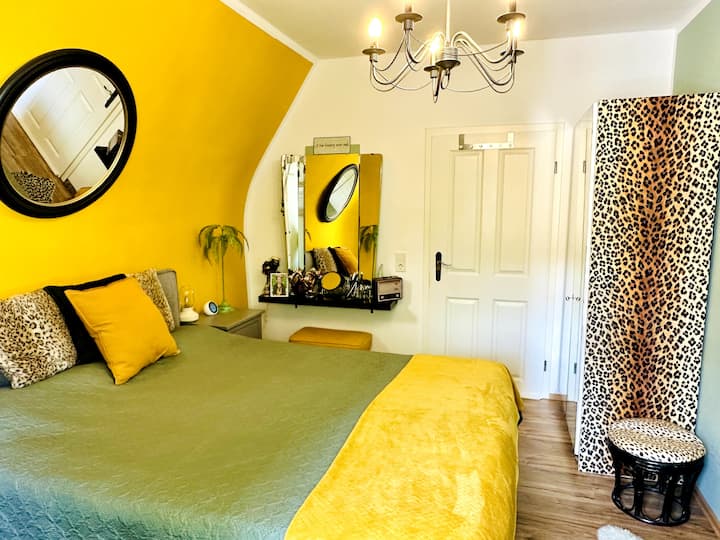 Nuestro dormitorio, amueblado con estilo, tiene 2 armarios, una cama tamaño «king», una silla de vestir, una cómoda, dos mesitas de noche y un tocador. Si le gusta la música, puede acceder a un reproductor de radio/CD.
