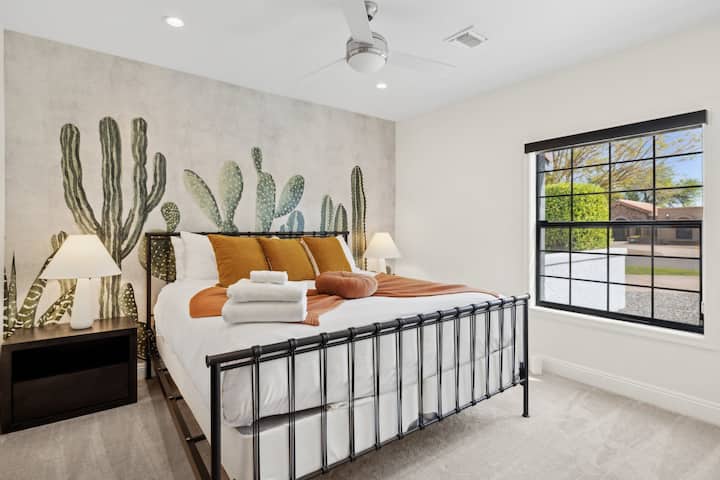 Large saguaro cactus artwork adorns the walls, creating a desert-inspired ambiance as you relax in the comfort of the king-size bed.